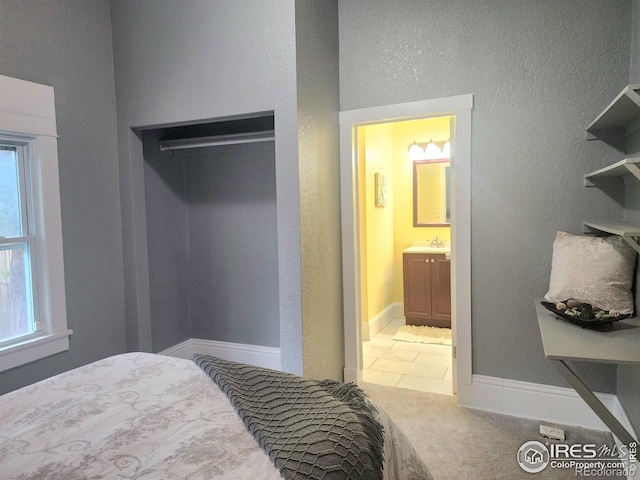 936 E 4th St, Loveland, CO 80537 - bedroom with a sink, carpet flooring, a textured wall, and ensuite bath