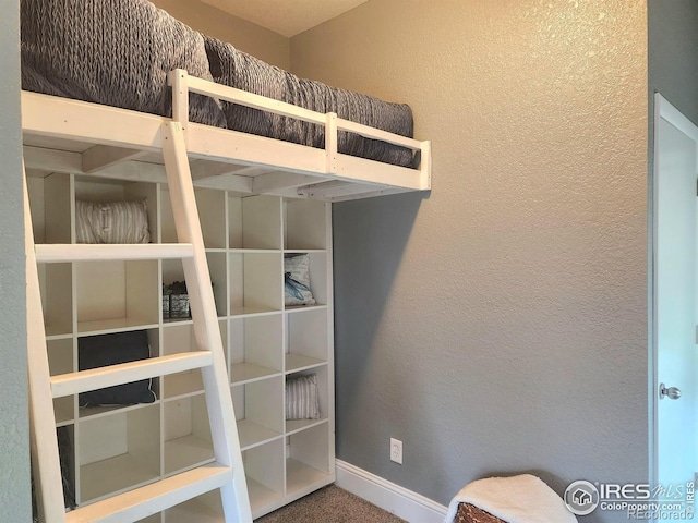 936 E 4th St, Loveland, CO 80537 - unfurnished bedroom featuring carpet, a textured wall, and baseboards