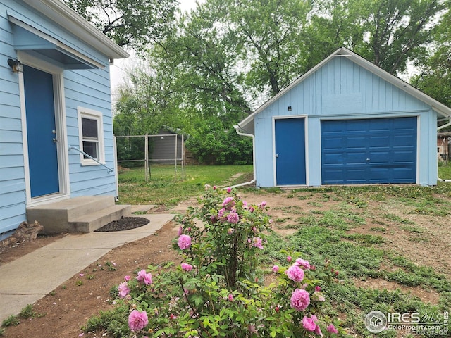 936 E 4th St, Loveland, CO 80537 - view of yard with an outdoor structure, a garage, and driveway