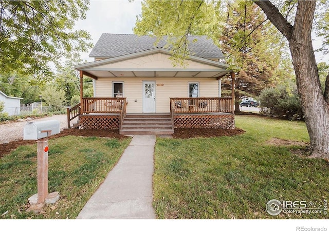 1155 Monroe Ave, Loveland, CO 80537 - bungalow-style house featuring covered porch, a front lawn, and roof with shingles