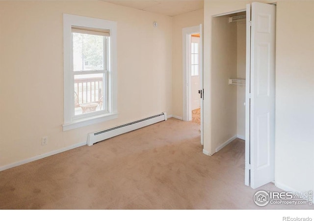 1155 Monroe Ave, Loveland, CO 80537 - unfurnished bedroom featuring a baseboard heating unit, carpet, and baseboards