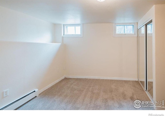 1155 Monroe Ave, Loveland, CO 80537 - basement featuring a baseboard heating unit, carpet, and baseboards