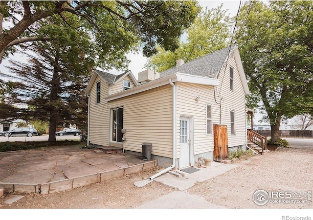 1155 Monroe Ave, Loveland, CO 80537 - view of side of property featuring entry steps and a patio area