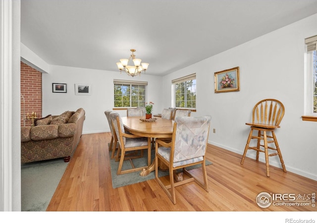 266 Gap Rd, Black Hawk, CO 80422 - dining room featuring light wood-type flooring, a chandelier, and baseboards