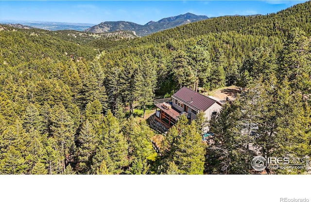 141 Millionaire Dr W, Boulder, CO 80302 - aerial view of property and surrounding area with a forest and a mountain backdrop