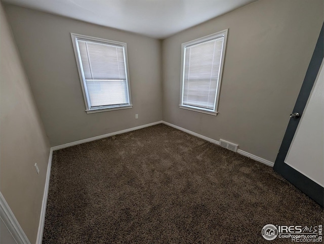 525 Jackson St, Sterling, CO 80751 - unfurnished room with dark carpet and baseboards