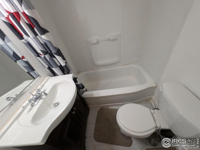 525 Jackson St, Sterling, CO 80751 - full bath with toilet, vanity, tile patterned flooring, and shower / bath combo with shower curtain