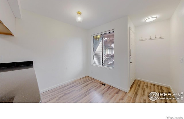 6110 Habitat Dr Unit 2, Boulder, CO 80301 - unfurnished dining area featuring wood finished floors and baseboards