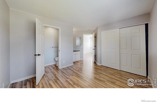 6110 Habitat Dr Unit 2, Boulder, CO 80301 - unfurnished bedroom featuring light wood-style flooring, a closet, and baseboards