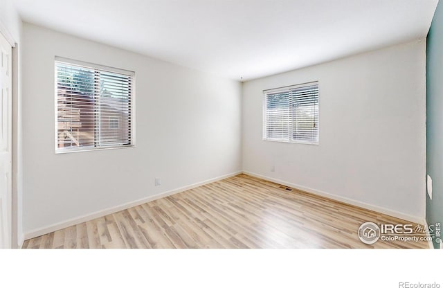 6110 Habitat Dr Unit 2, Boulder, CO 80301 - unfurnished room with healthy amount of natural light, wood finished floors, and baseboards