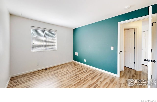 6110 Habitat Dr Unit 2, Boulder, CO 80301 - unfurnished room with wood finished floors, baseboards, and a smoke detector