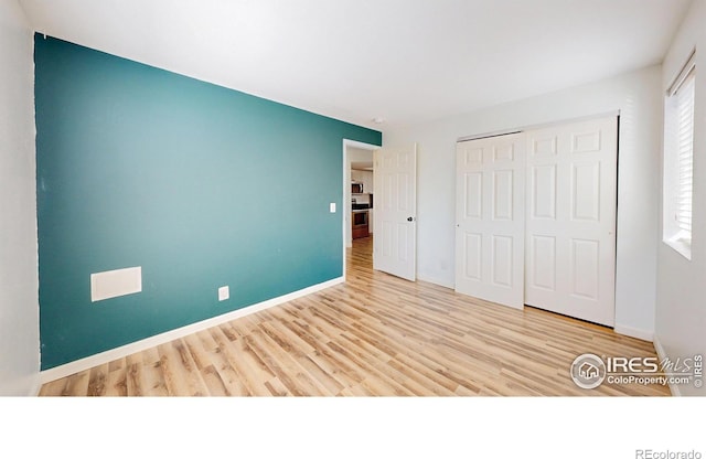 6110 Habitat Dr Unit 2, Boulder, CO 80301 - unfurnished bedroom with wood finished floors, a closet, and baseboards