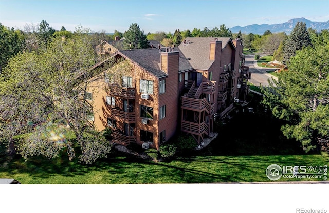 6110 Habitat Dr Unit 2, Boulder, CO 80301 - back of house featuring a mountain view, a chimney, and a yard