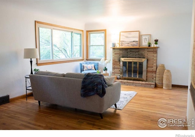 508 W 11th St, Loveland, CO 80537 - living area with wood finished floors, baseboards, and a fireplace