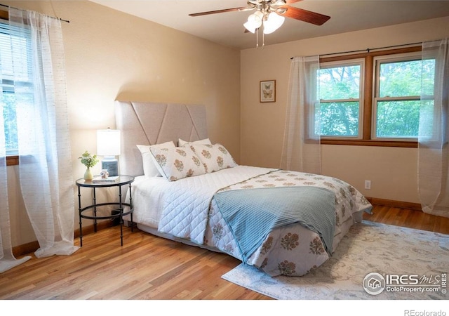 508 W 11th St, Loveland, CO 80537 - bedroom featuring wood finished floors, baseboards, and a ceiling fan