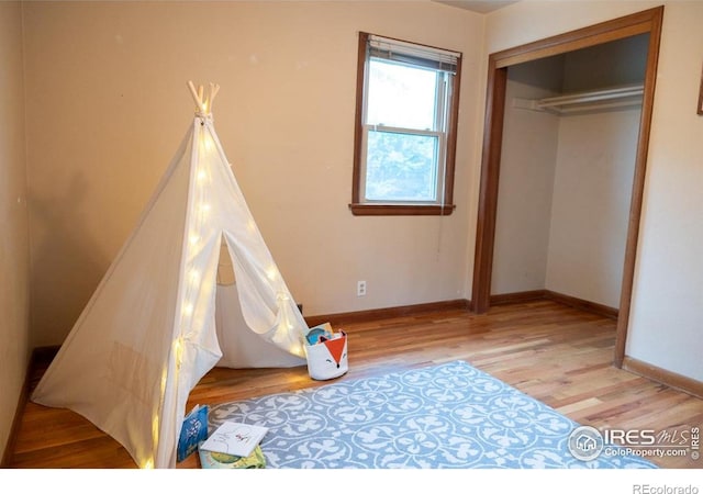 508 W 11th St, Loveland, CO 80537 - unfurnished bedroom with light wood finished floors, baseboards, and a closet