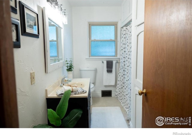 508 W 11th St, Loveland, CO 80537 - bathroom with toilet, vanity, and a shower with shower curtain