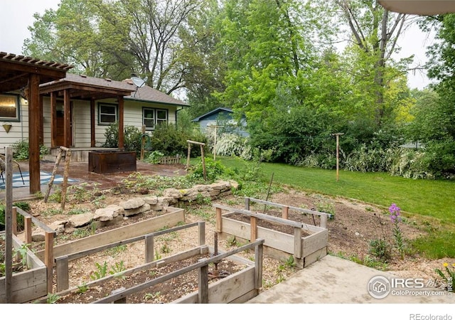 508 W 11th St, Loveland, CO 80537 - view of grassy yard with a garden