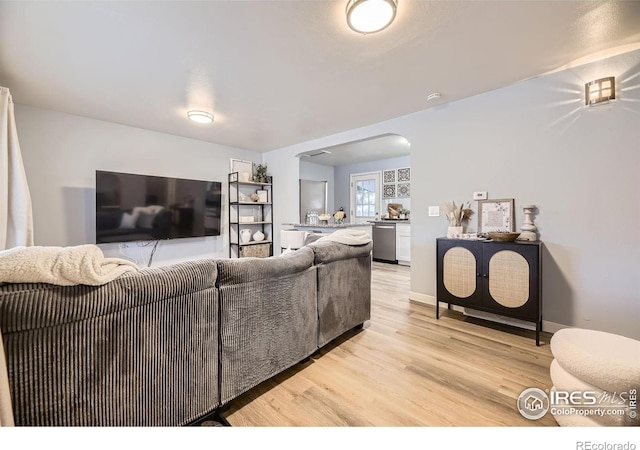 3245 W Walsh Pl, Denver, CO 80219 - living area featuring arched walkways and light wood-style flooring
