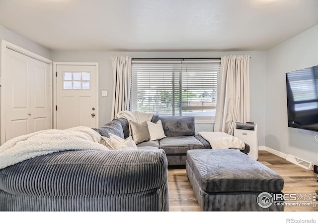 3245 W Walsh Pl, Denver, CO 80219 - living room featuring healthy amount of natural light, wood finished floors, and baseboards