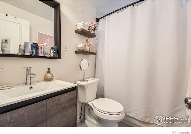 3245 W Walsh Pl, Denver, CO 80219 - bathroom featuring toilet, vanity, and a shower with curtain