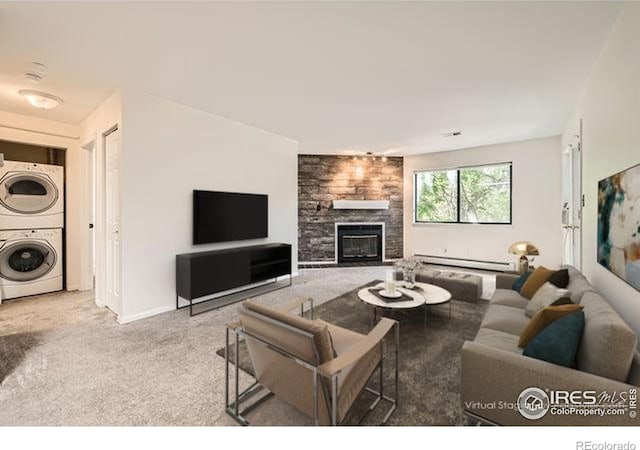 1830 22nd St Unit 15, Boulder, CO 80302 - carpeted living area featuring stacked washing machine and dryer, a baseboard radiator, and a large fireplace