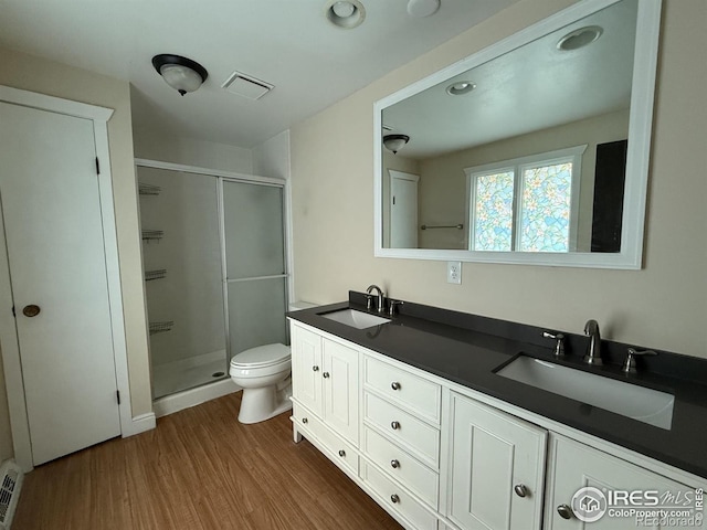 1943 Meadow Dr Unit B2, Longmont, CO 80501 - bathroom with a stall shower, wood finished floors, toilet, and double vanity