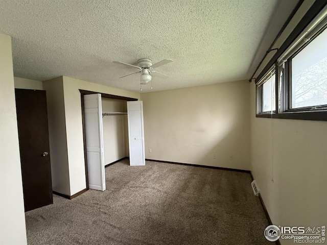 1943 Meadow Dr Unit B2, Longmont, CO 80501 - unfurnished bedroom featuring carpet, a closet, baseboards, a ceiling fan, and a textured ceiling