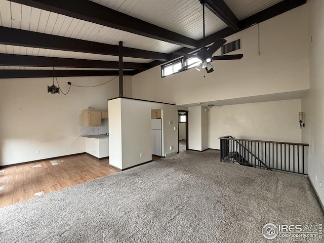 1943 Meadow Dr Unit B2, Longmont, CO 80501 - carpeted spare room featuring a ceiling fan, baseboards, beam ceiling, high vaulted ceiling, and wood finished floors