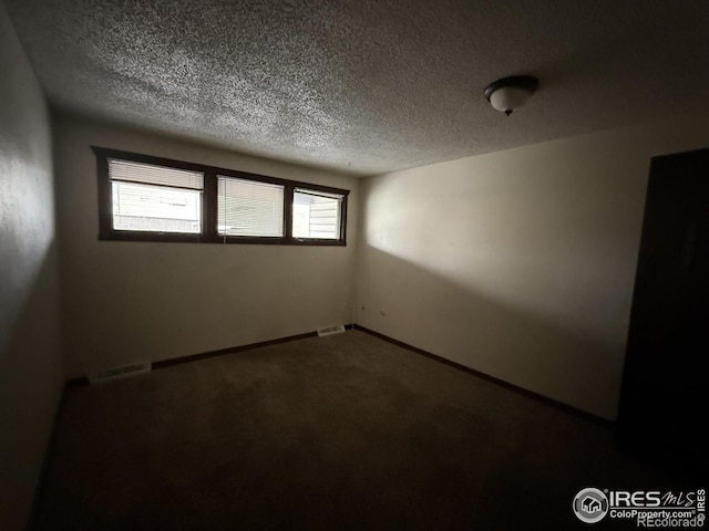 1943 Meadow Dr Unit B2, Longmont, CO 80501 - carpeted spare room with a textured ceiling and baseboards