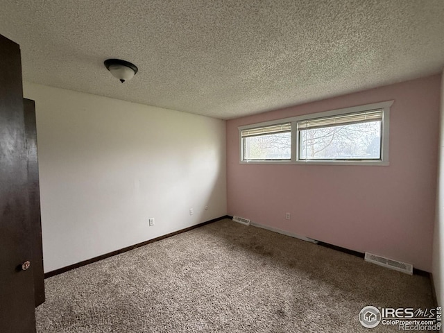 1943 Meadow Dr Unit B2, Longmont, CO 80501 - carpeted spare room featuring a textured ceiling and baseboards