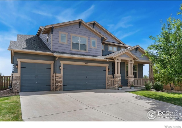 6614 Neota Creek Ct, Timnath, CO 80547 - craftsman-style house with covered porch, concrete driveway, an attached garage, and stone siding
