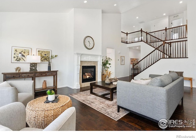6614 Neota Creek Ct, Timnath, CO 80547 - living room featuring stairway, dark wood-style flooring, a high ceiling, baseboards, and recessed lighting