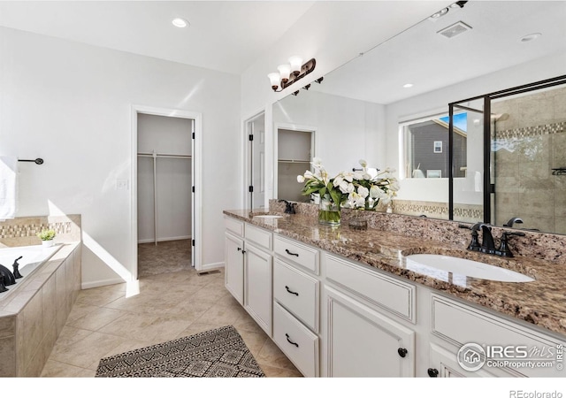 6614 Neota Creek Ct, Timnath, CO 80547 - bathroom with a shower stall, double vanity, a garden tub, a spacious closet, and recessed lighting