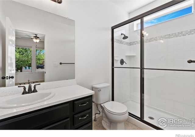 6614 Neota Creek Ct, Timnath, CO 80547 - full bathroom with a shower stall, vanity, toilet, and ceiling fan