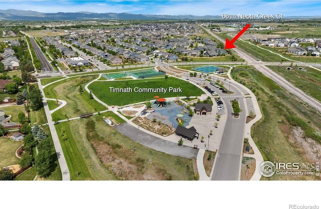 6614 Neota Creek Ct, Timnath, CO 80547 - aerial view of property and surrounding area with nearby suburban area and a mountainous background
