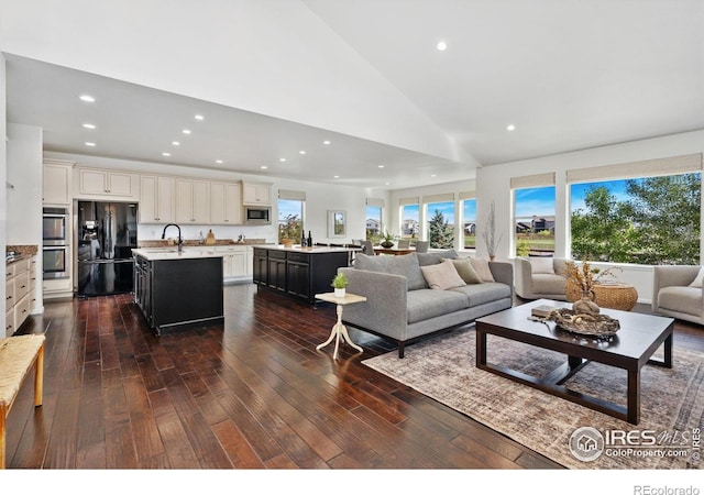 6614 Neota Creek Ct, Timnath, CO 80547 - living area featuring recessed lighting, dark wood-type flooring, and vaulted ceiling
