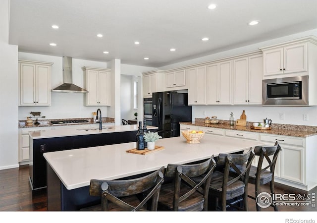 6614 Neota Creek Ct, Timnath, CO 80547 - kitchen with wall chimney range hood, freestanding refrigerator, an island with sink, built in microwave, and a sink