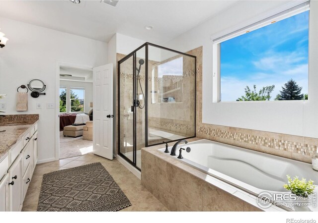 6614 Neota Creek Ct, Timnath, CO 80547 - ensuite bathroom featuring a garden tub, vanity, a stall shower, and tile patterned floors