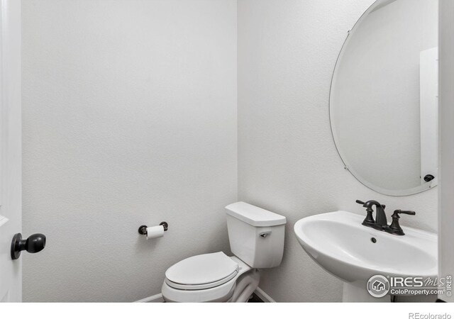 6614 Neota Creek Ct, Timnath, CO 80547 - half bath with a sink, toilet, and baseboards
