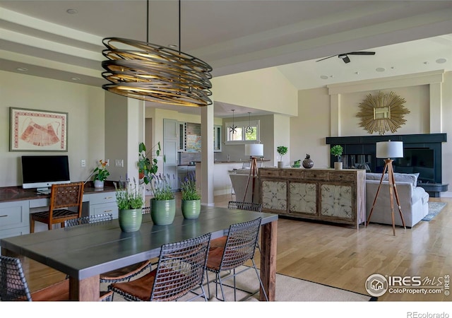 7205 Rustic Trl, Boulder, CO 80301 - dining room with light wood-style floors, a fireplace, a chandelier, and lofted ceiling