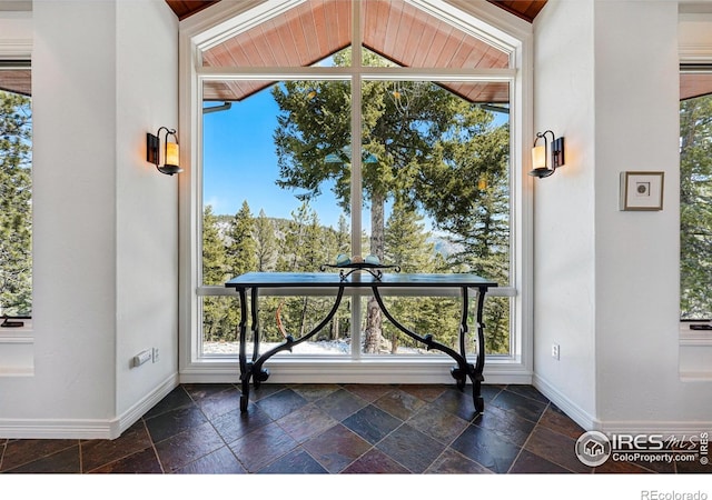 290 Skyhill Dr, Evergreen, CO 80439 - entryway featuring baseboards, stone tile floors, and lofted ceiling