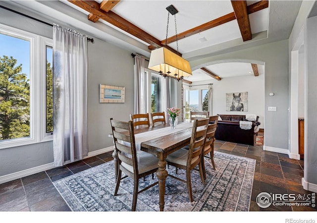 290 Skyhill Dr, Evergreen, CO 80439 - dining area featuring beamed ceiling, arched walkways, stone tile flooring, a chandelier, and coffered ceiling