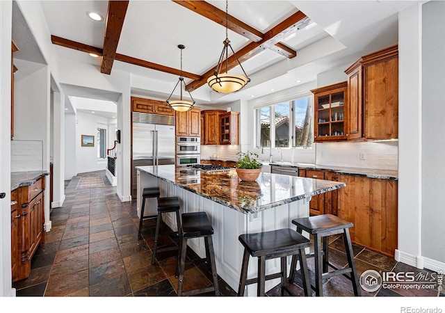 290 Skyhill Dr, Evergreen, CO 80439 - kitchen with brown cabinets, stone tile floors, a kitchen island, decorative backsplash, and glass insert cabinets