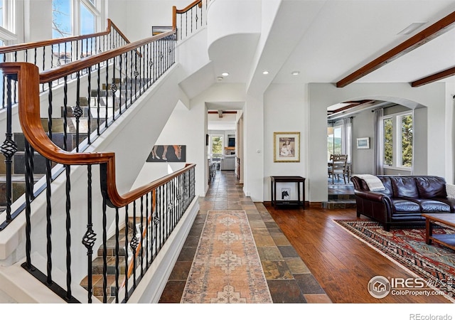 290 Skyhill Dr, Evergreen, CO 80439 - living area featuring arched walkways, recessed lighting, stone tile floors, stairway, and baseboards