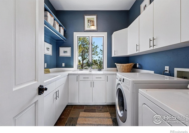 290 Skyhill Dr, Evergreen, CO 80439 - laundry area featuring washing machine and dryer, cabinet space, and stone tile floors