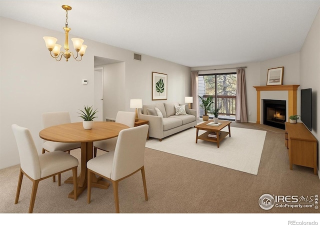 316 Wright St Unit 203, Lakewood, CO 80228 - carpeted dining space with a chandelier and a fireplace with flush hearth