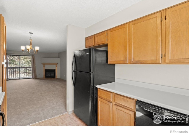 316 Wright St Unit 203, Lakewood, CO 80228 - kitchen with black appliances, light countertops, a chandelier, open floor plan, and hanging light fixtures