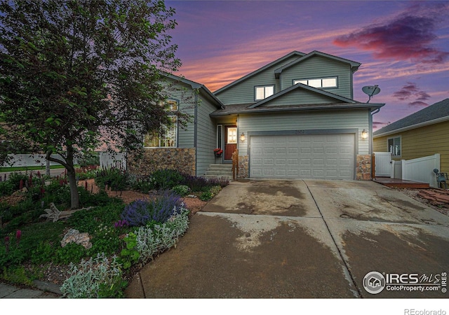2502 Ballard Ln, Fort Collins, CO 80524 - traditional-style house featuring stone siding, a garage, and driveway