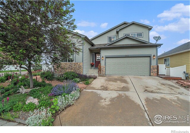 2502 Ballard Ln, Fort Collins, CO 80524 - traditional home featuring stone siding, driveway, and an attached garage